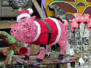 A pig by folk artist Clyde Jones all dressed up for the Christmas holiday in a Santa suit. Photo by bobistraveling.