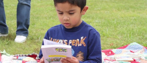 A young child reads at Day of the Book