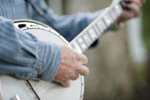 Closeup shot of man playing banjo