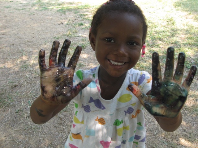 Little girl with paint on hands