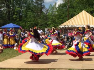 Photograph of Takiri Folclor Latino Dancers twirling brightly colored skirts