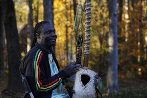 Photo of Diali Cissokho smiling and playing the kora