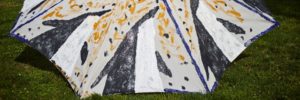 Canvas, paint, glitter folk art umbrella by Clyde Jones.