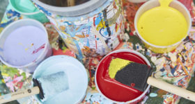 Photo of cups filled with brightly colored paints