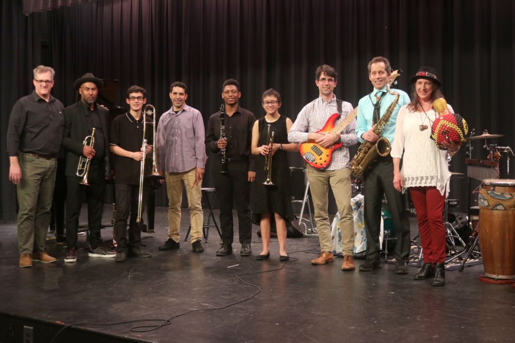 JM High School students standing with members of the La Fiesta Latin Jazz sextet