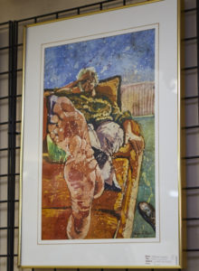 Photo of watercolor batik painting of a barefooted woman lying on a couch