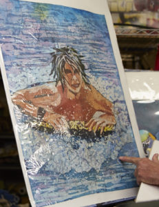 Photo of watercolor batik painting of boy in the ocean