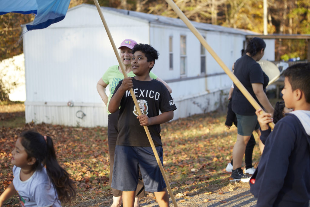 Photo of boy holding one of the poles for the 5-person puppet