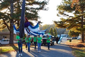 Photo of volunteers carrying giant 5-person puppet