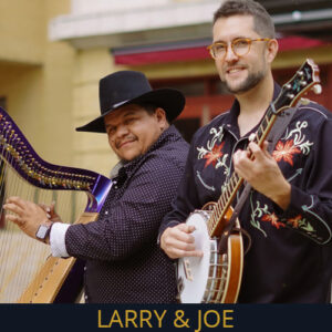 Photograph - headshot of Larry & Joe. Larry is playing a harp, Joe is holding a banjo