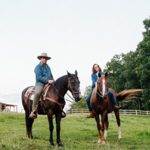 Photo featuring Austin and Sarah McCombie sitting on horseback