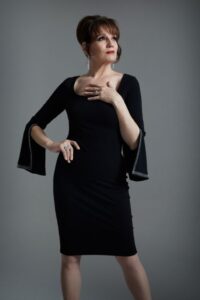 Photo featuring Beth Leavel in a black dress