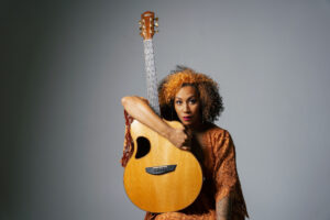 Photo featuring musician Rissi Palmer holding a guitar