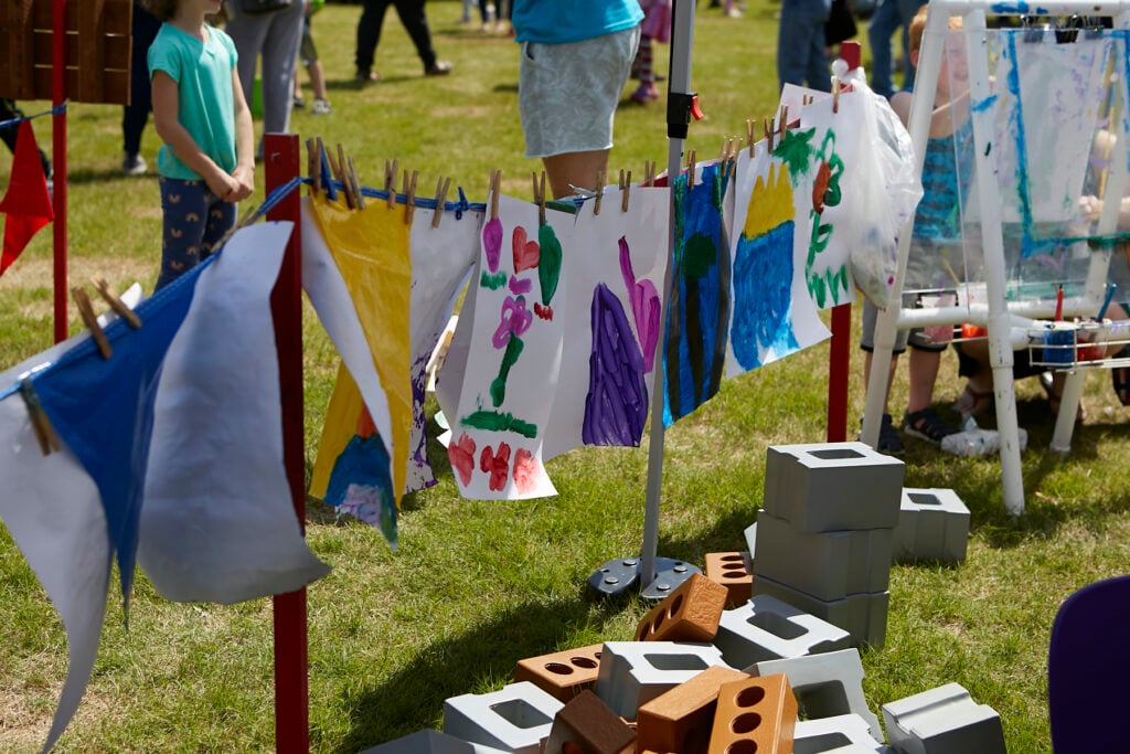 Photo of a "clothesline" of children's paintings hanging to dry