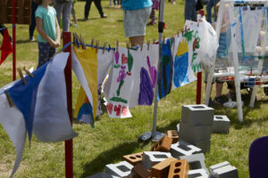 Photo of a "clothesline" of children's paintings hanging to dry