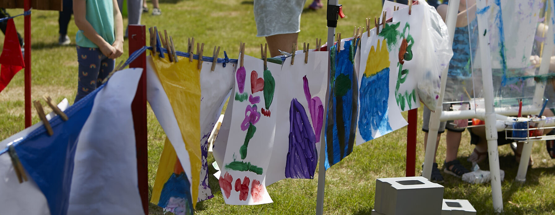 Photo of a "clothesline" of children's paintings hanging to dry