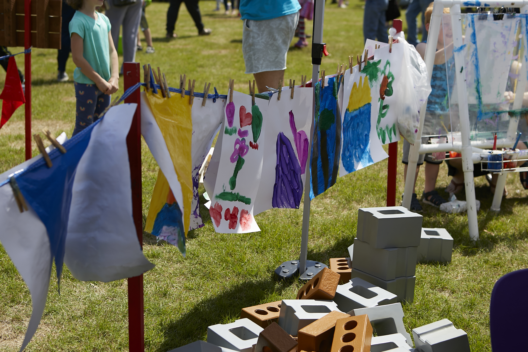 Children's works of arts hanging on a line to dry