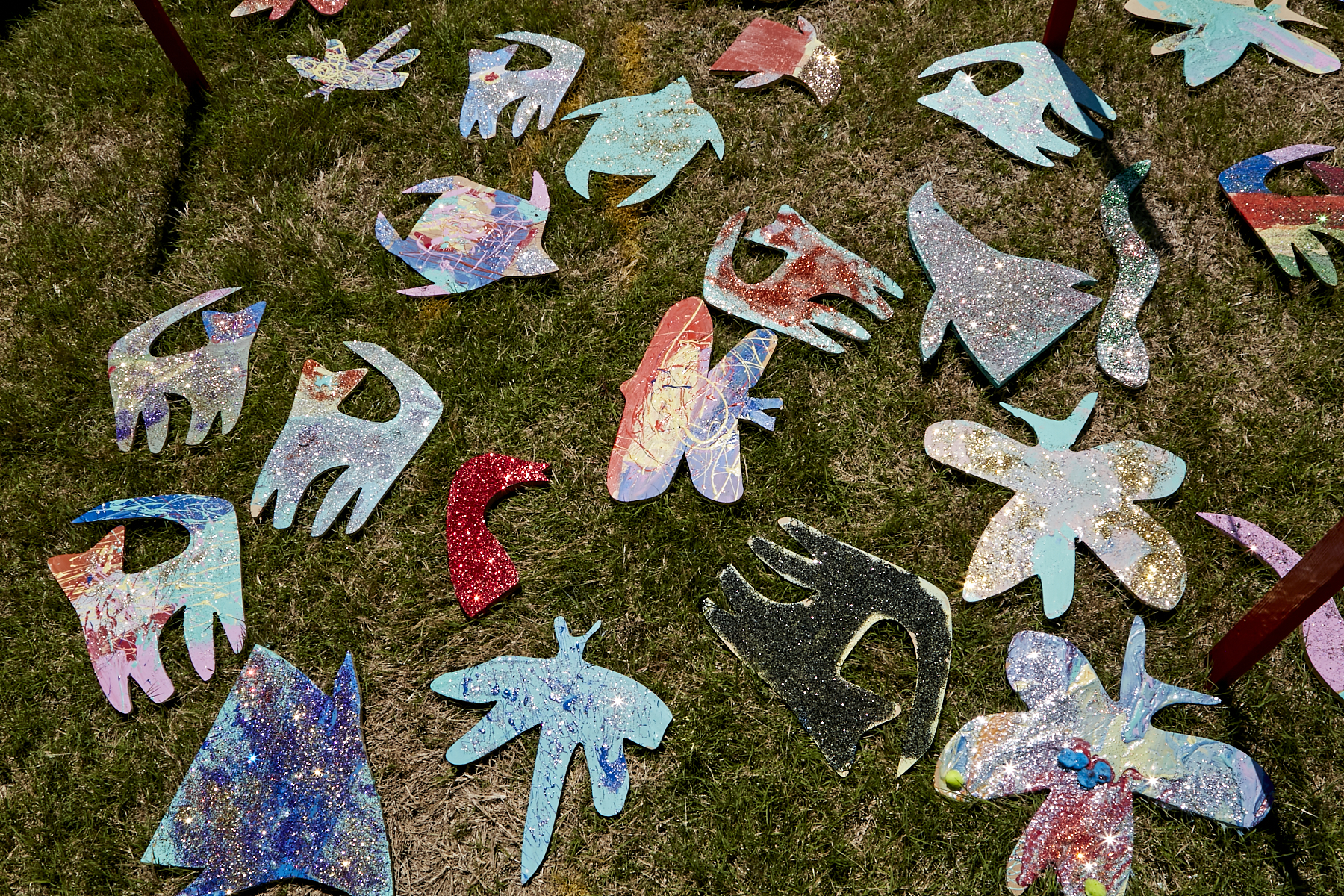Photo of wooden critter cut-outs laid out to allow the paint to dry