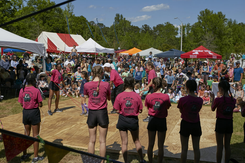 Photograph of Bouncing Bulldogs jumprope team with huge crowd in the background. 