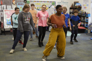 Aya Shabu, in front, leads a group of students in an African dance