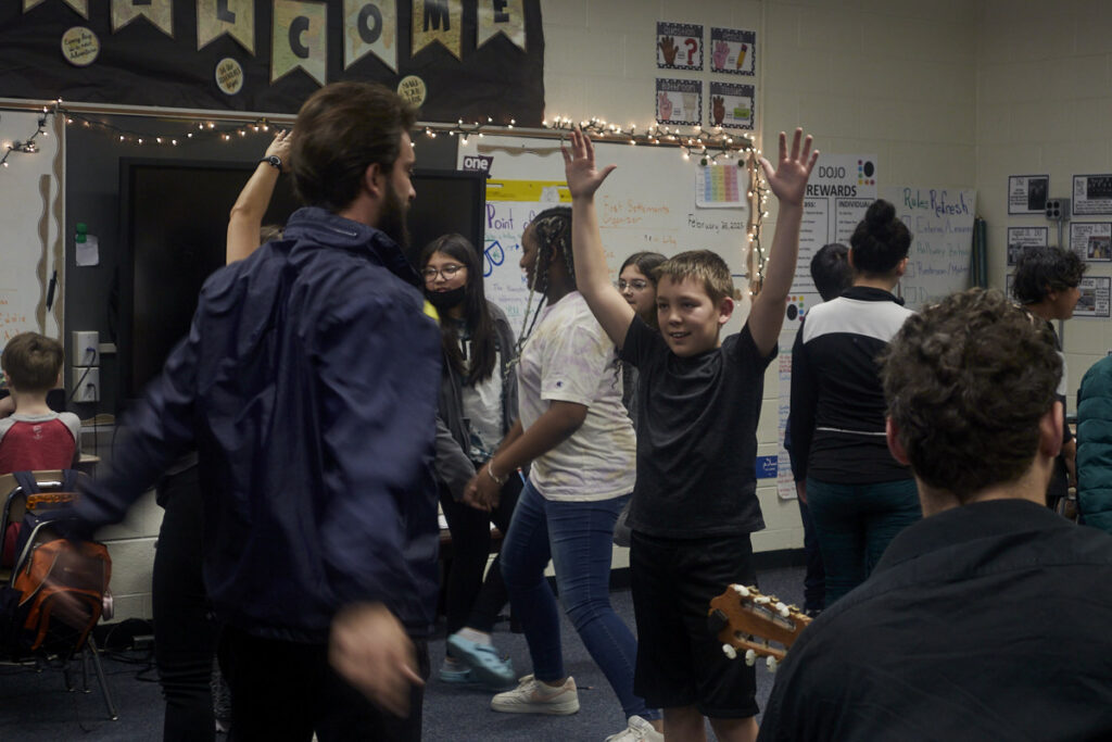 Photo of Flamenco Vivo performers teaching students how to perform flamenco dance moves