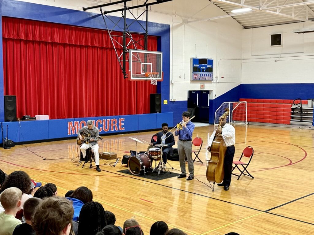 Photo of John Brown Band playing in the gym at Bennett School