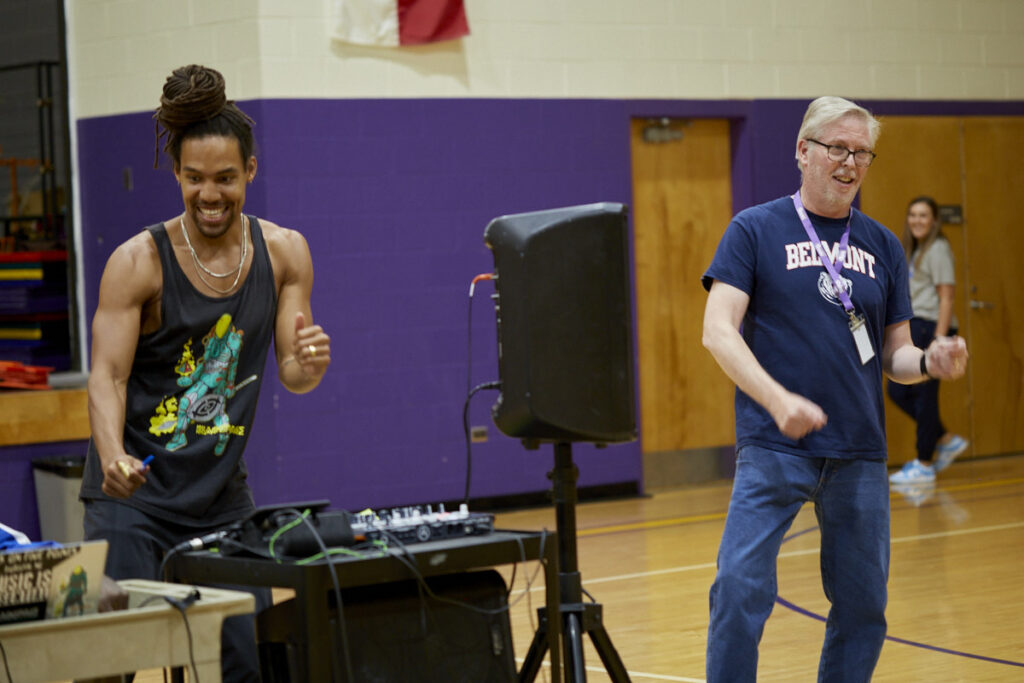 Pierce and a teacher dance to an electronic beat made by a student