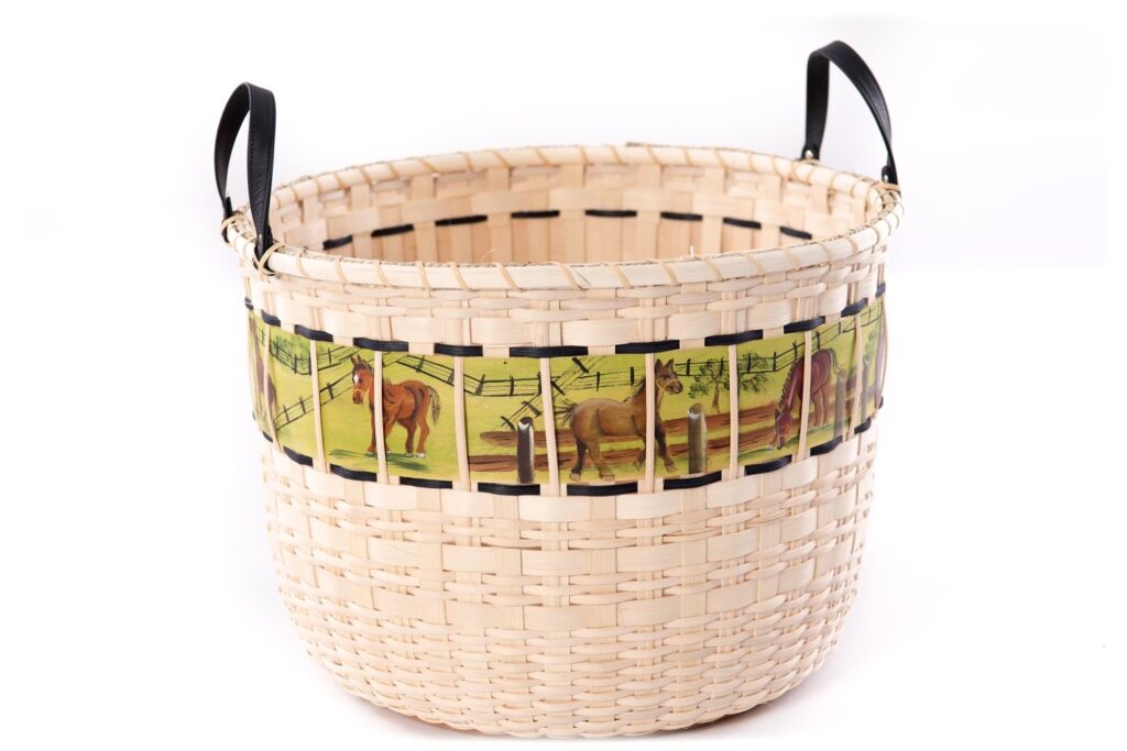 a basket woven with one large panel handpainted with horses