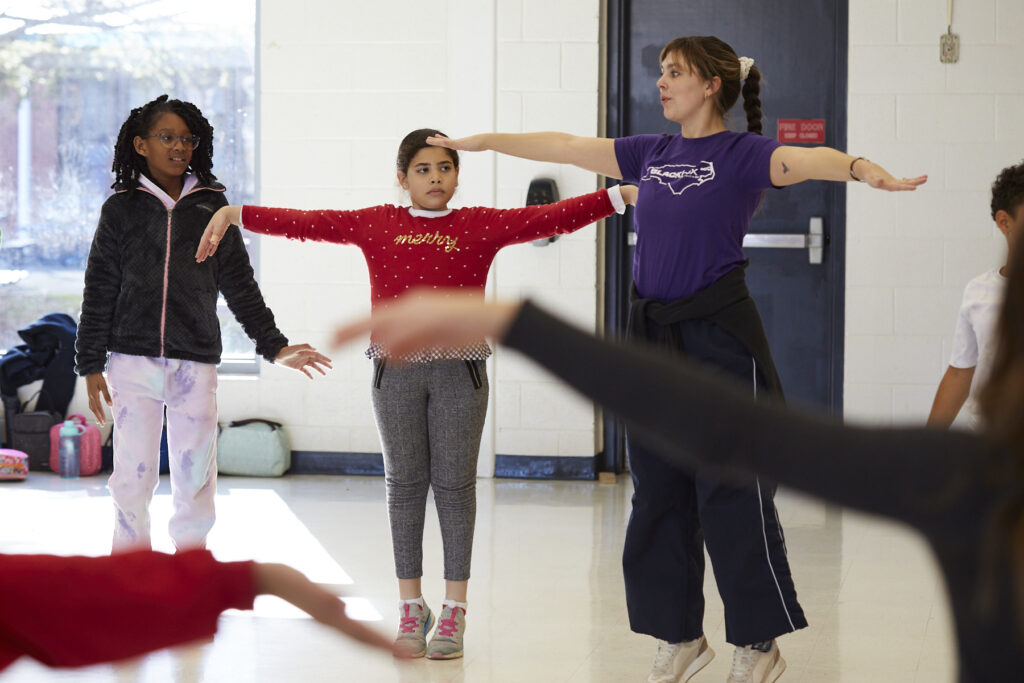 Black Box dancers lead fourth graders in dance at Pittsboro Elementary.