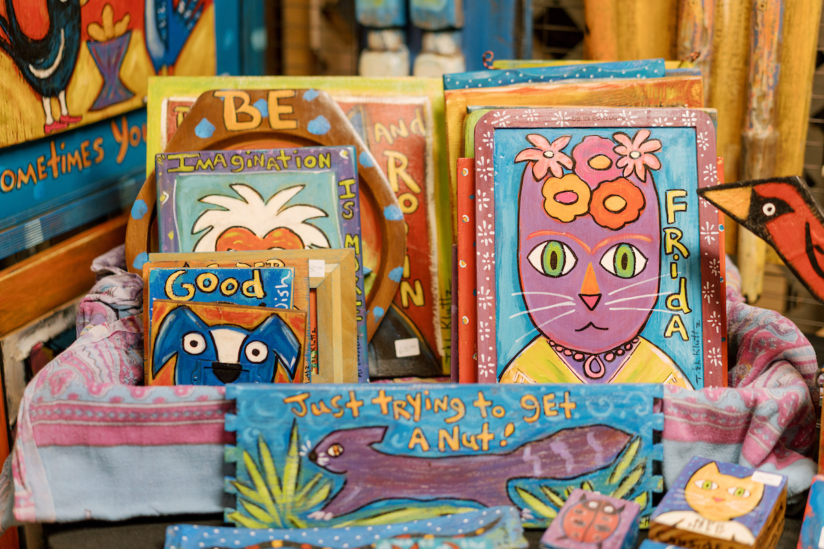 a display of brightly colored painted cards and plaques