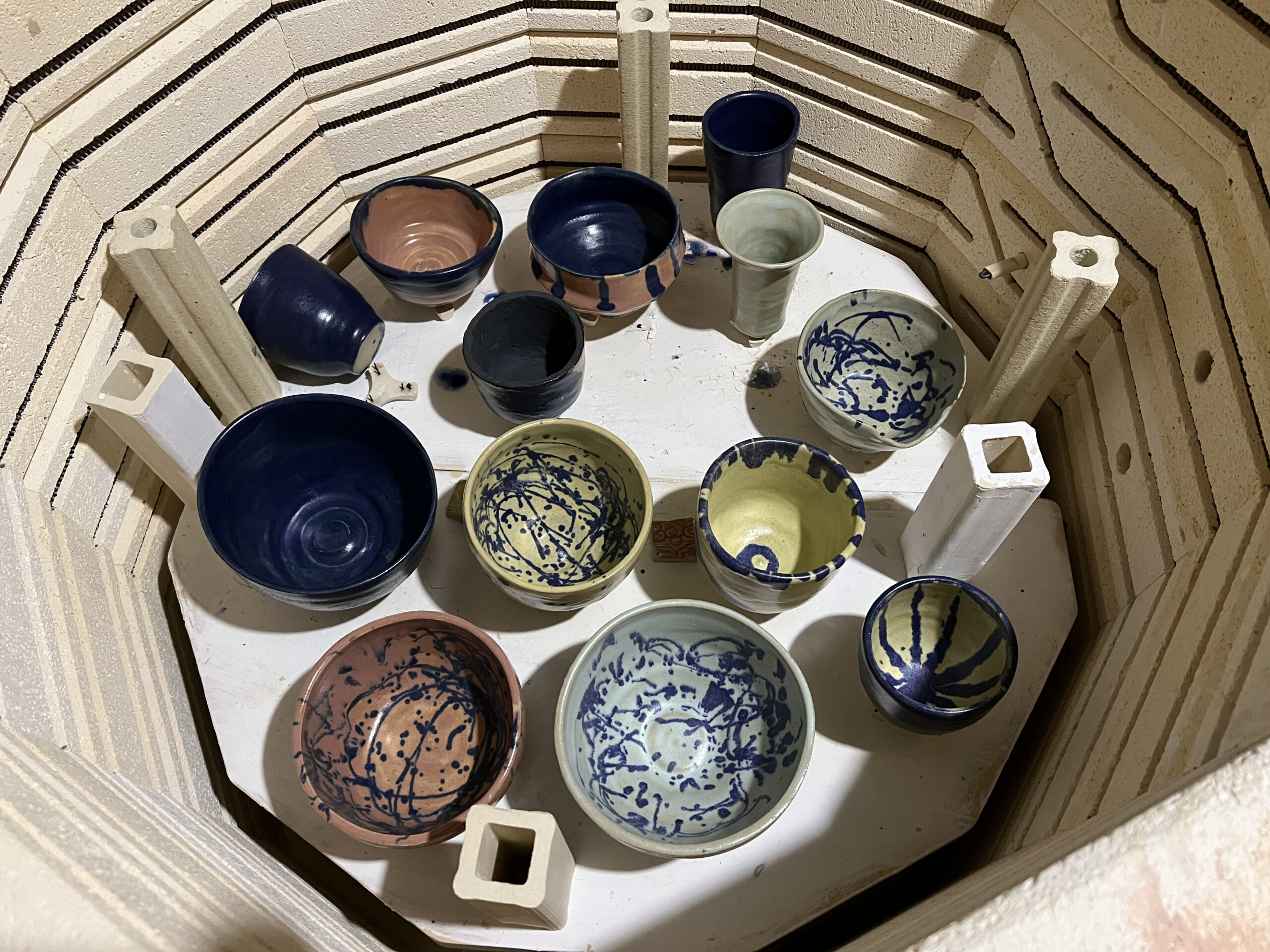a basket filled with ceramic bowls of varied shapes and sizes