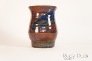 a handmade ceramic vase in brown and blue.