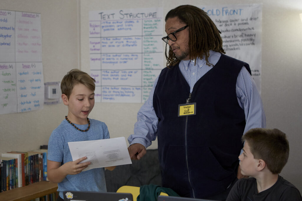 Poet Phillip Shabazz instructs a class of fifth grade students on poetry writing.
