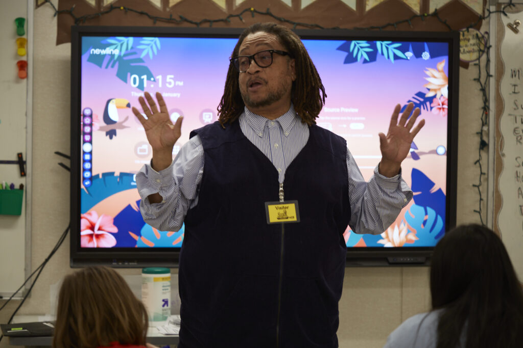 Poet Phillip Shabazz instructs a class of fifth grade students on poetry writing.