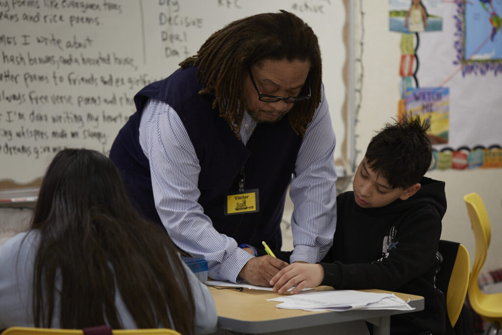 Poet Phillip Shabazz instructs a class of fifth grade students on poetry writing.