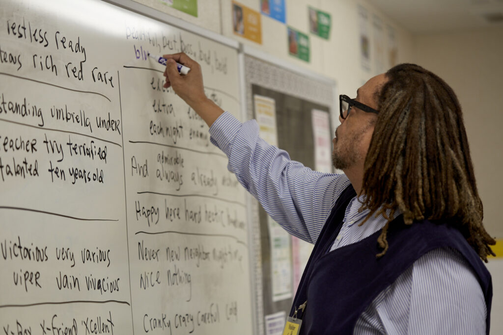Poet Phillip Shabazz instructs a class of fifth grade students on poetry writing.