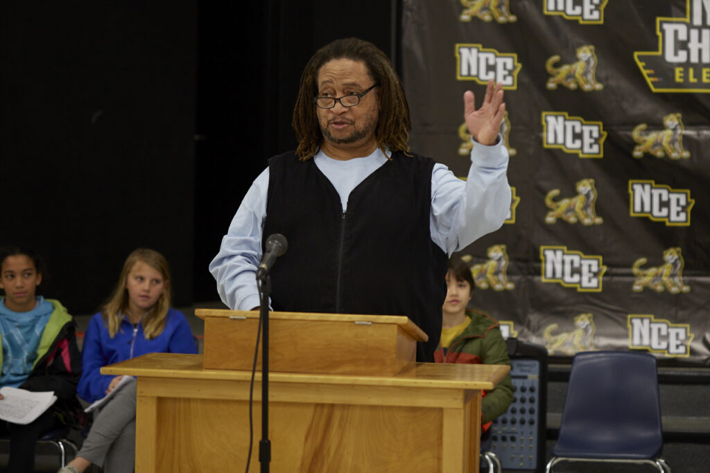 Poet Phillip Shabazz instructs a class of fifth grade students on poetry writing.