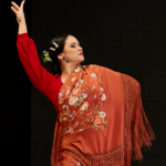 A flamenco dancer and students