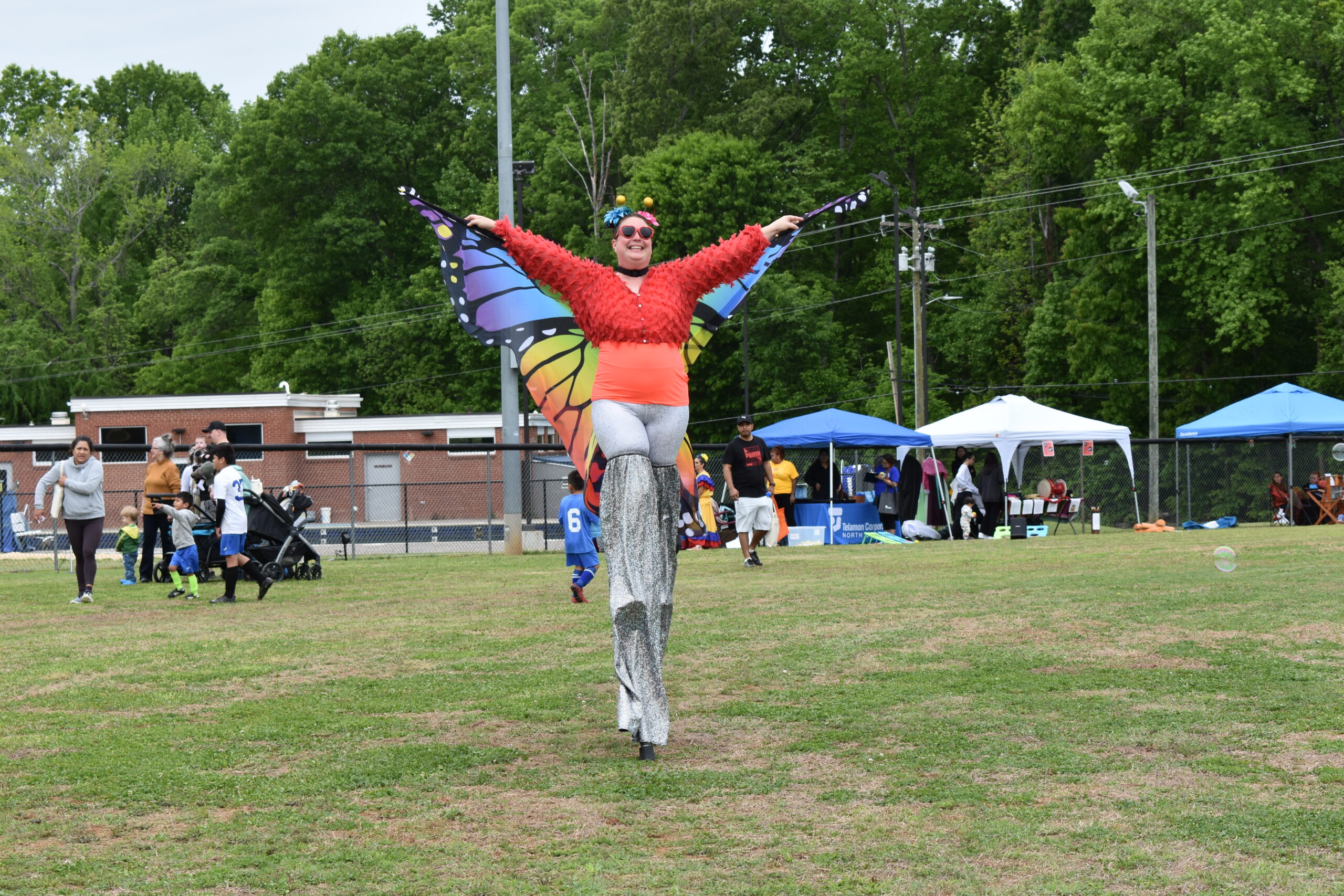 a woman on stilts with butterfly wings