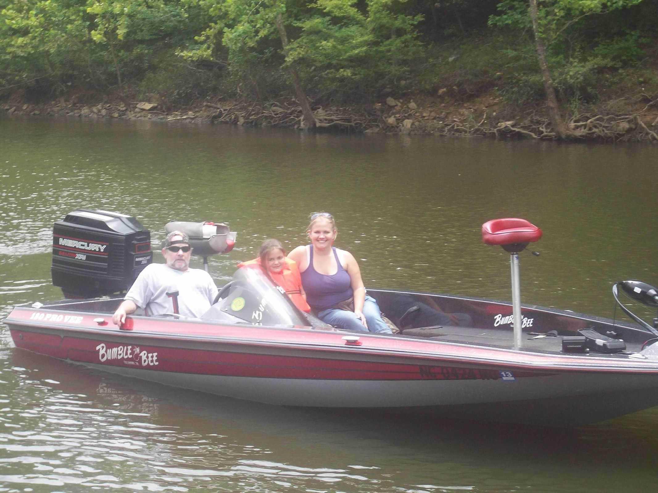 A group of three boating on a lake.