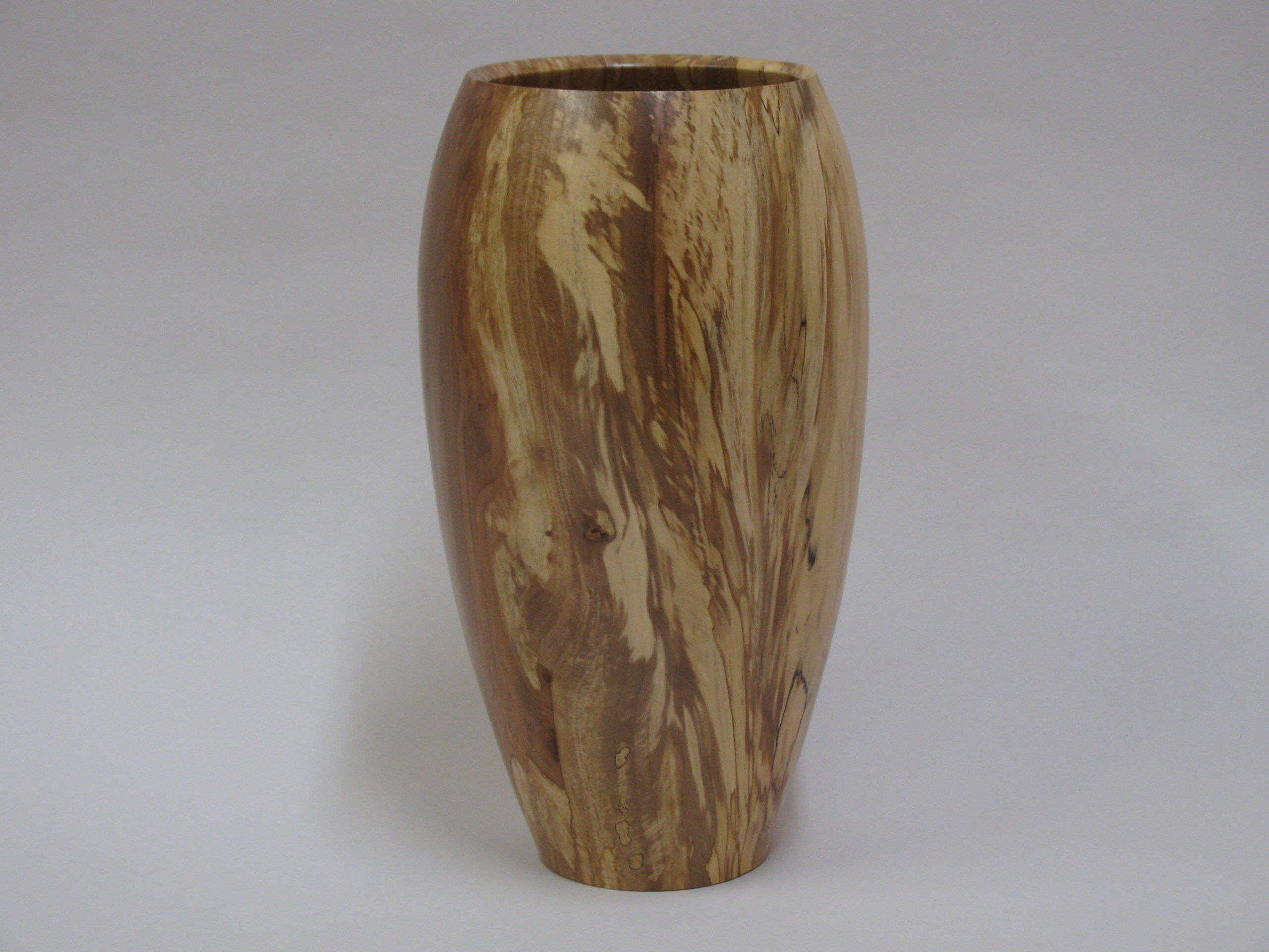 a studio photo of a wooden vase.