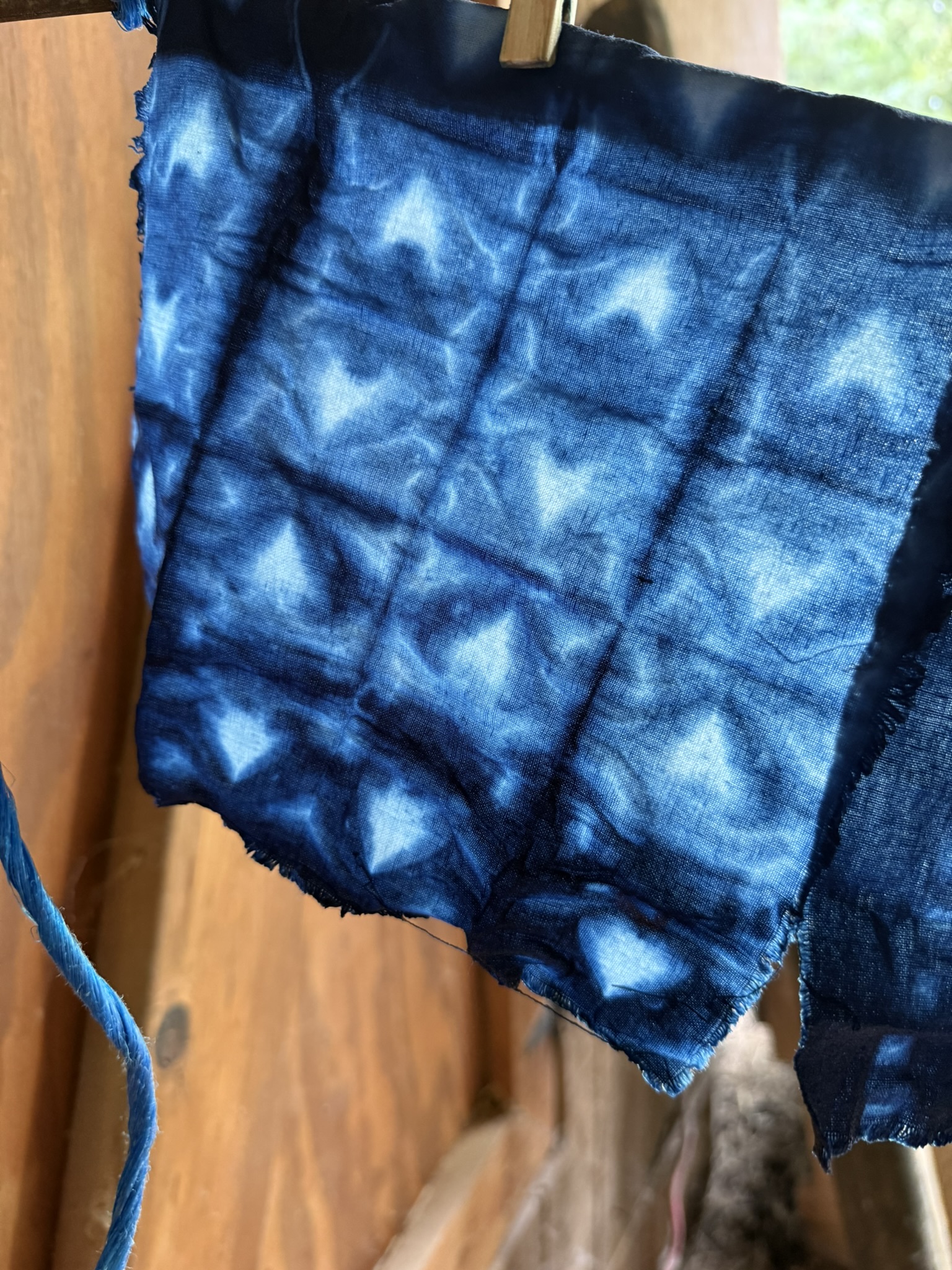 Close up of indigo dyed fabric with squares and hearts on it.